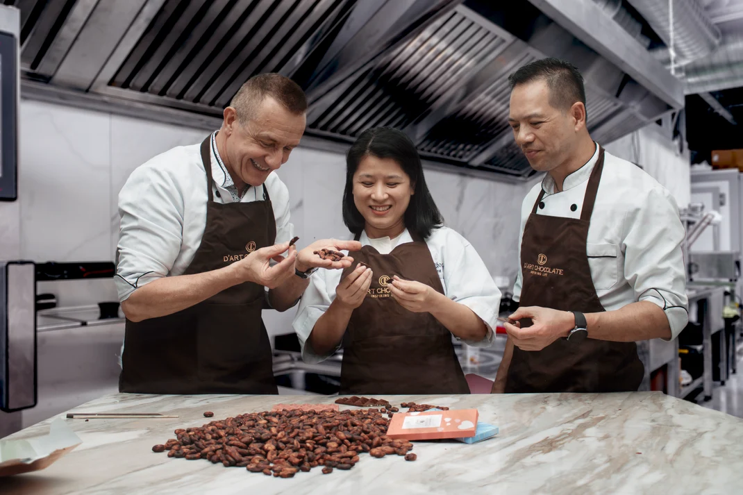 Staff inspecting beans at the bench in the production kitchen